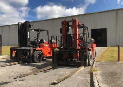 a pair of nissan forklifts from the 90s